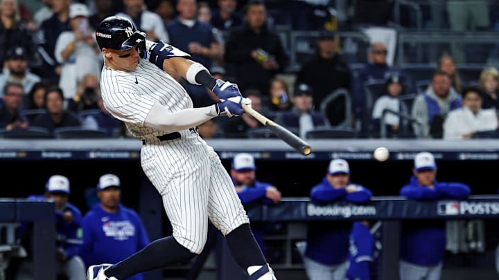 Oct 8, 2025; Bronx, New York, USA; New York Yankees right fielder Aaron Judge (99) hits a single during the first inning against the Toronto Blue Jays during game four of the ALDS round for the 2025 MLB playoffs at Yankee Stadium. Mandatory Credit: Vincent Carchietta-Imagn Images