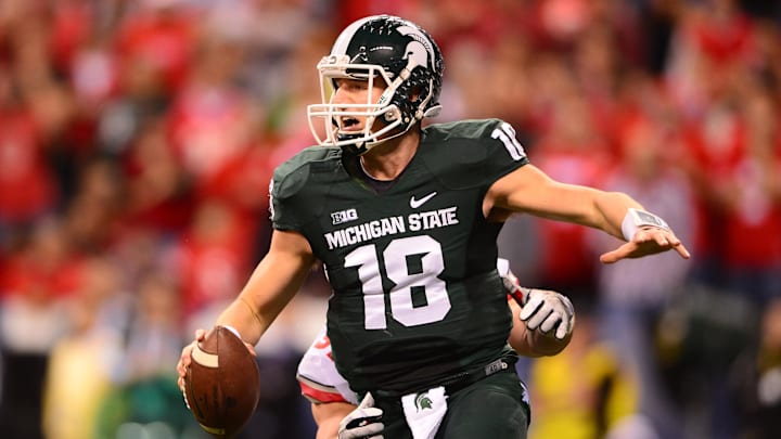 Dec 7, 2013; Indianapolis, IN, USA; Michigan State Spartans quarterback Connor Cook (18) scrambles out of the pocket during the second quarter of the 2013 Big 10 Championship game against the Ohio State Buckeyes at Lucas Oil Stadium. Mandatory Credit: Andrew Weber-Imagn Images Dec 7, 2013; Indianapolis, IN, USA; Michigan State Spartans quarterback Connor Cook (18) scrambles out of the pocket during the second quarter of the 2013 Big 10 Championship game against the Ohio State Buckeyes at Lucas Oil Stadium. Mandatory Credit: Andrew Weber-Imagn Images