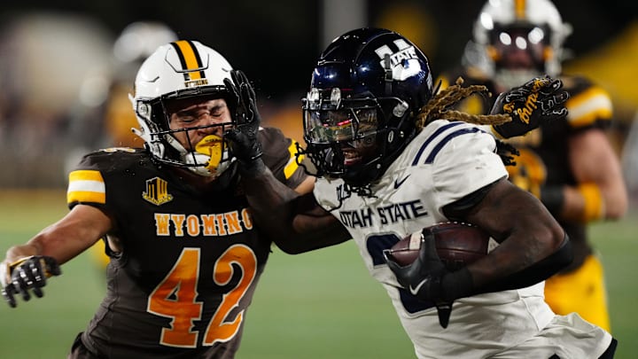 Oct 26, 2024; Laramie, Wyoming, USA; Utah State Aggies running back Rahsul Faison (3) runs against the Wyoming Cowboys during the second quarter at Jonah Field at War Memorial Stadium. Mandatory Credit: Troy Babbitt-Imagn Images