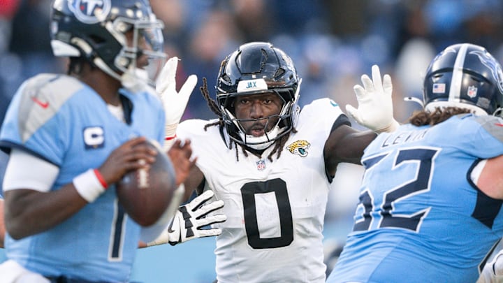 Nov 30, 2025; Nashville, Tennessee, USA;  Jacksonville Jaguars linebacker Devin Lloyd (0) rushes Tennessee Titans quarterback Cameron Ward (1) during the second half at Nissan Stadium. Mandatory Credit: Steve Roberts-Imagn Images