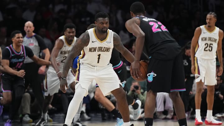 Jan 4, 2026; Miami, Florida, USA;  New Orleans Pelicans forward Zion Williamson (1) defends Miami Heat forward Andrew Wiggins (22) during the second half at Kaseya Center. Mandatory Credit: Jim Rassol-Imagn Images