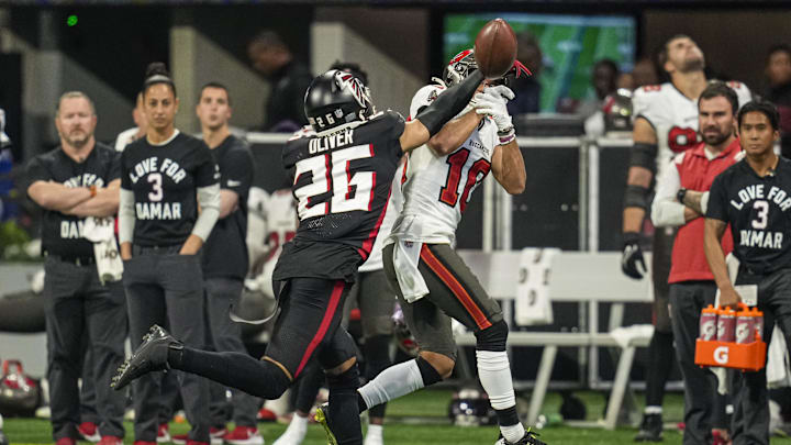 Jan 8, 2023; Atlanta, Georgia, USA; Atlanta Falcons cornerback Isaiah Oliver (26) deflects a pass in front of Tampa Bay Buccaneers wide receiver Scotty Miller (10) during the second  half at Mercedes-Benz Stadium. Mandatory Credit: Dale Zanine-Imagn Images