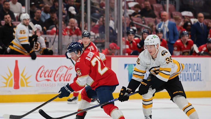 Apr 2, 2026; Sunrise, Florida, USA; Florida Panthers defenseman Tobias Bjornfot (22) moves the puck against Boston Bruins center Morgan Geekie (39) during the second period at Amerant Bank Arena. Mandatory Credit: Sam Navarro-Imagn Images