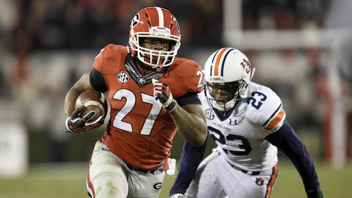 Nov 15, 2014; Athens, GA, USA; Georgia Bulldogs running back Nick Chubb (27) runs past Auburn Tigers defensive back Johnathan Ford (23) during the second half at Sanford Stadium. Georgia defeated Auburn 34-7. Mandatory Credit: Dale Zanine-Imagn Images