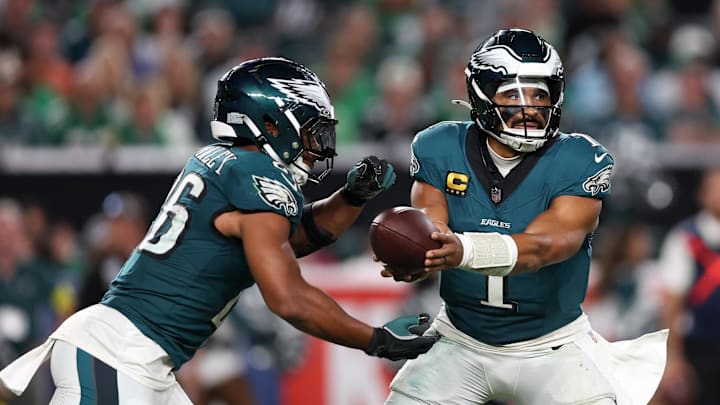 Sep 4, 2025; Philadelphia, Pennsylvania, USA; Philadelphia Eagles quarterback Jalen Hurts (1) hands off the ball to running back Saquon Barkley (26) during the third quarter of the game against the Dallas Cowboys at Lincoln Financial Field. Mandatory Credit: Bill Streicher-Imagn Images Sep 4, 2025; Philadelphia, Pennsylvania, USA; Philadelphia Eagles quarterback Jalen Hurts (1) hands off the ball to running back Saquon Barkley (26) during the third quarter of the game against the Dallas Cowboys at Lincoln Financial Field. Mandatory Credit: Bill Streicher-Imagn Images