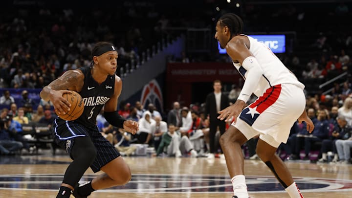 Apr 3, 2025; Washington, District of Columbia, USA; Orlando Magic forward Paolo Banchero (5) dribbles the ball as Washington Wizards forward Alex Sarr (20) defends in the first half at Capital One Arena. Mandatory Credit: Geoff Burke-Imagn Images
