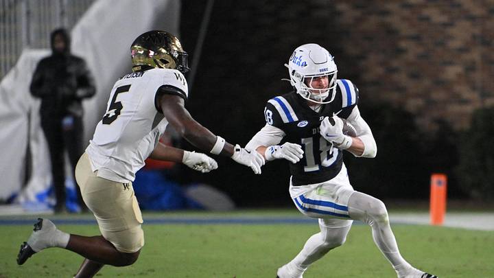 Nov 29, 2025; Durham, North Carolina, USA; Duke Blue Devils wide receiver Cooper Barkate (18) runs the ball against Wake Forest Demon Deacons defensive back Davaughn Patterson (5) during the third quarter at Wallace Wade Stadium. Mandatory Credit: Zachary Taft-Imagn Images Nov 29, 2025; Durham, North Carolina, USA; Duke Blue Devils wide receiver Cooper Barkate (18) runs the ball against Wake Forest Demon Deacons defensive back Davaughn Patterson (5) during the third quarter at Wallace Wade Stadium. Mandatory Credit: Zachary Taft-Imagn Images