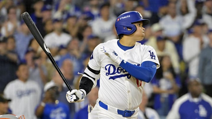 Los Angeles Dodgers designated hitter Shohei Ohtani (17) hits an RBI single in the sixth inning against the New York Mets during game six of the NLCS for the 2024 MLB playoffs at Dodger Stadium on Oct 20.