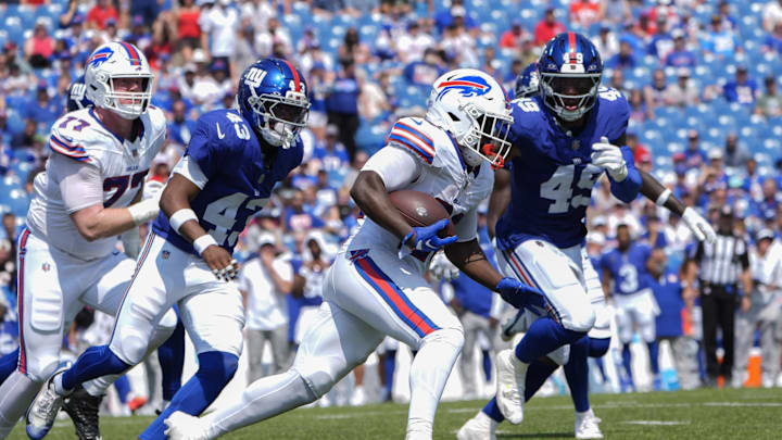 Aug 9, 2025; Orchard Park, New York, USA; Buffalo Bills running back Frank Gore Jr. (20) runs with the ball after making a catch against New York Giants safety Raheem Layne (43) and New York Giants linebacker Chris Board (49) during the second half at Highmark Stadium.  
