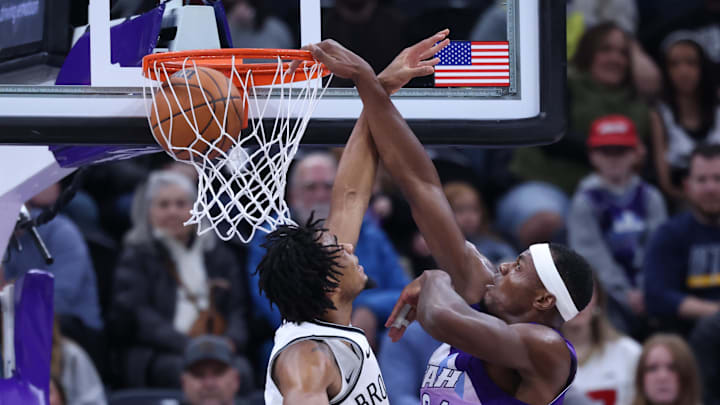 Jan 12, 2025; Salt Lake City, Utah, USA; Utah Jazz center Oscar Tshiebwe (34) dunks the ball against Brooklyn Nets center Nic Claxton (33) during the second quarter at Delta Center. Mandatory Credit: Rob Gray-Imagn Images
