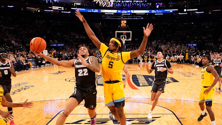 Mar 15, 2024; New York City, NY, USA;  Providence Friars guard Devin Carter (22) drives on Marquette Golden Eagles guard Tre Norman (5) during the second half at Madison Square Garden. Mandatory Credit: Robert Deutsch-USA TODAY Sports
