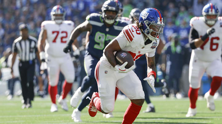 Oct 6, 2024; Seattle, Washington, USA; New York Giants running back Eric Gray (20) runs for yards after the coach against the Seattle Seahawks during the first quarter at Lumen Field. Oct 6, 2024; Seattle, Washington, USA; New York Giants running back Eric Gray (20) runs for yards after the coach against the Seattle Seahawks during the first quarter at Lumen Field.