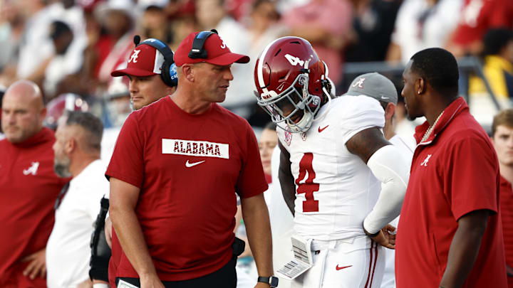 Oct 5, 2024; Nashville, Tennessee, USA; Alabama Crimson Tide head coach Kalen DeBoer talks with quarterback Jalen Milroe (4) during the second half against the Vanderbilt Commodores at FirstBank Stadium. Mandatory Credit: Butch Dill-Imagn Images