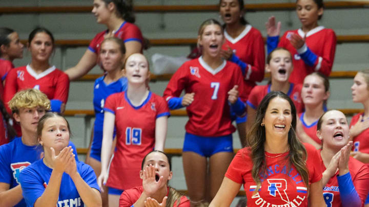 Roncalli volleyball coach Christina Erazmus smiles while watching her team in a match against Carmel in August. The Royals, who won that match, are No. 20 in this week's High School on SI Top 25 Girls Volleyball National Rankings.