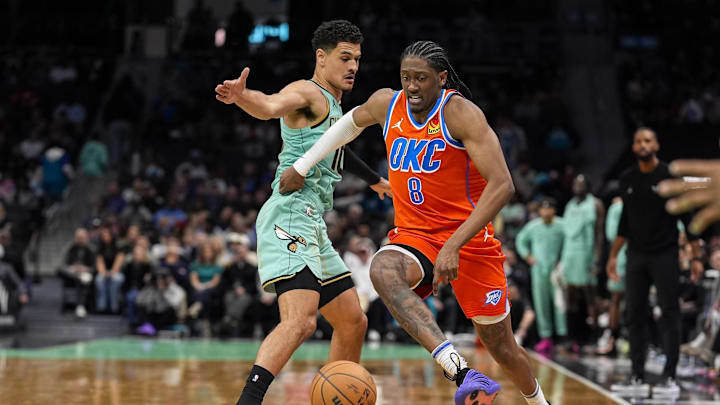 Dec 28, 2024; Charlotte, North Carolina, USA; Oklahoma City Thunder forward Jalen Williams (8) dribbles the ball against Charlotte Hornets guard Josh Green (10) during the second half at Spectrum Center. Mandatory Credit: Jim Dedmon-Imagn Images