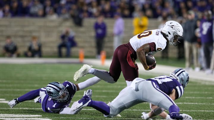 Nov 16, 2024; Manhattan, Kansas, USA; Arizona State Sun Devils wide receiver Jordyn Tyson (0) is tackled by Kansas State Wildcats linebacker Austin Moore (41) and cornerback Keenan Garber (1) during the first quarter at Bill Snyder Family Football Stadium. Mandatory Credit: Scott Sewell-Imagn Images Nov 16, 2024; Manhattan, Kansas, USA; Arizona State Sun Devils wide receiver Jordyn Tyson (0) is tackled by Kansas State Wildcats linebacker Austin Moore (41) and cornerback Keenan Garber (1) during the first quarter at Bill Snyder Family Football Stadium. Mandatory Credit: Scott Sewell-Imagn Images