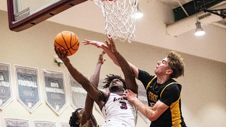 Jayden Petit of the First Baptist Academy boys basketball team drives to the basket against Bishop Verot during the Private 8 Championship at FBA on Friday, Jan. 24, 2025. He is defended by Austin Leslie, right, of Bishop Verot. FBA won.