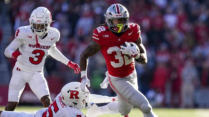 Ohio State Buckeyes running back Isaiah West (32) runs over Rutgers Scarlet Knights defensive back Kaj Sanders (5) during the second half of the NCAA football game at Ohio Stadium in Columbus on Nov. 22, 2025. Ohio State won 42-9. Ohio State Buckeyes running back Isaiah West (32) runs over Rutgers Scarlet Knights defensive back Kaj Sanders (5) during the second half of the NCAA football game at Ohio Stadium in Columbus on Nov. 22, 2025. Ohio State won 42-9.