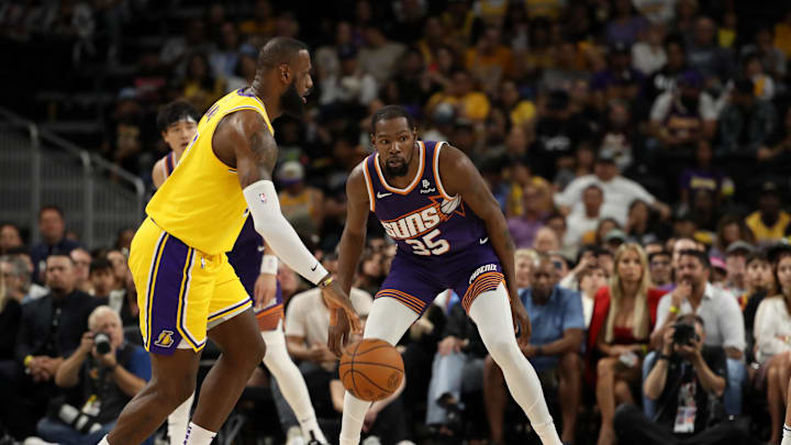 Phoenix Suns forward Kevin Durant (35) defends Los Angeles Lakers star LeBron James.