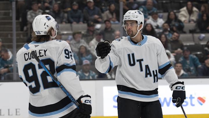 Dec 14, 2024; San Jose, California, USA;  Utah Hockey Club center Logan Cooley (92) celebrates with right wing Dylan Guenther (11) during the first period against the San Jose Sharks at SAP Center at San Jose. Mandatory Credit: Stan Szeto-Imagn Images