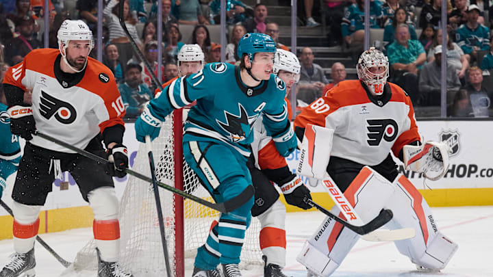 Mar 21, 2026; San Jose, California, USA; San Jose Sharks center Macklin Celebrini (71) stands in the goal crease against Philadelphia Flyers defenseman Jamie Drysdale (9), goaltender Dan Vladar (80) and left wing Garrett Wilson (10) during the second period at SAP Center at San Jose. Mandatory Credit: Robert Edwards-Imagn Images