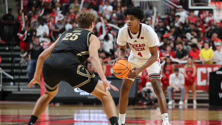 Nov 4, 2025; Lubbock, Texas, USA; Texas Tech Red Raiders guard Christian Anderson (4) dribbles the ball against Lindenwood Lions forward Todd Bieg (25) in the second half at United Supermarkets Arena. Mandatory Credit: Michael C. Johnson-Imagn Images