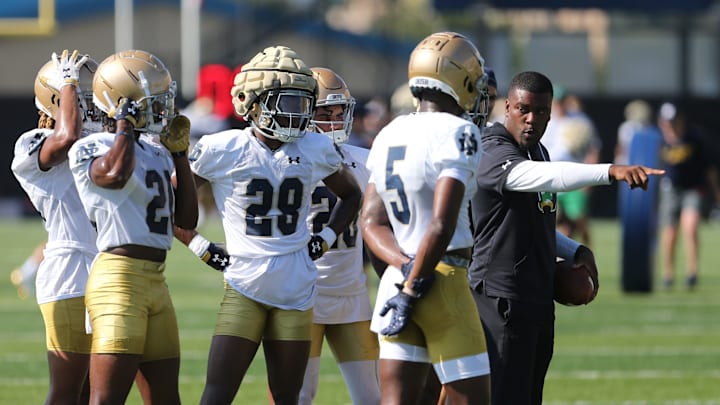 Notre Dame football cornerbacks coach Mike Mickens works with players