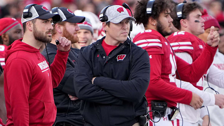Nov 26, 2022; Madison, Wisconsin, USA; Wisconsin head coach Jim Leonhard, center, is shown during the first quarter of their gam at Camp Randall Stadium. Mandatory Credit: Mark Hoffman-Imagn Images