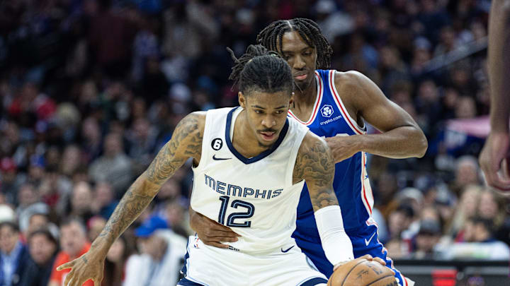 Memphis Grizzlies guard Ja Morant (12) controls the ball against Philadelphia 76ers guard Tyrese Maxey (0) during the third quarter at Wells Fargo Center. Mandatory Credit: Bill Streicher-Imagn Images