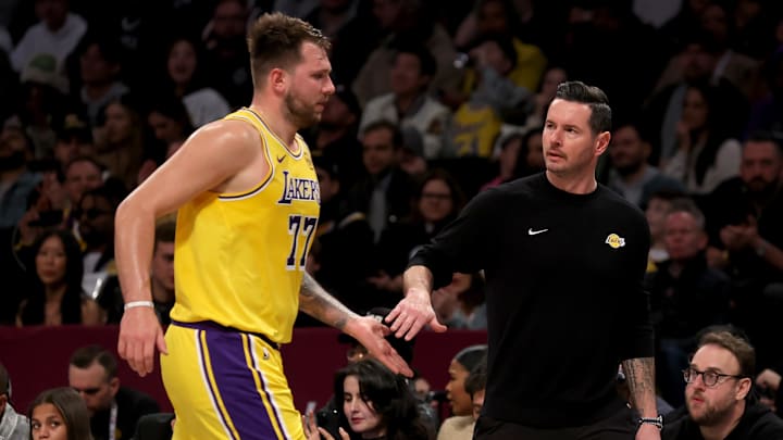Los Angeles Lakers guard Luka Doncic (77) high fives head coach JJ Redick. Los Angeles Lakers guard Luka Doncic (77) high fives head coach JJ Redick.