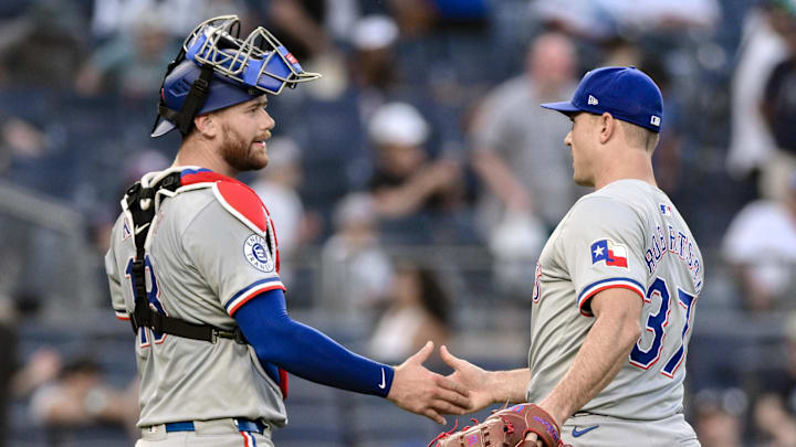 Texas Rangers pitcher David Robertson (37) shakes hands with Texas Rangers catcher Carson Kelly (18) after defeating the New York Yankees at Yankee Stadium in 2024. Texas Rangers pitcher David Robertson (37) shakes hands with Texas Rangers catcher Carson Kelly (18) after defeating the New York Yankees at Yankee Stadium in 2024.