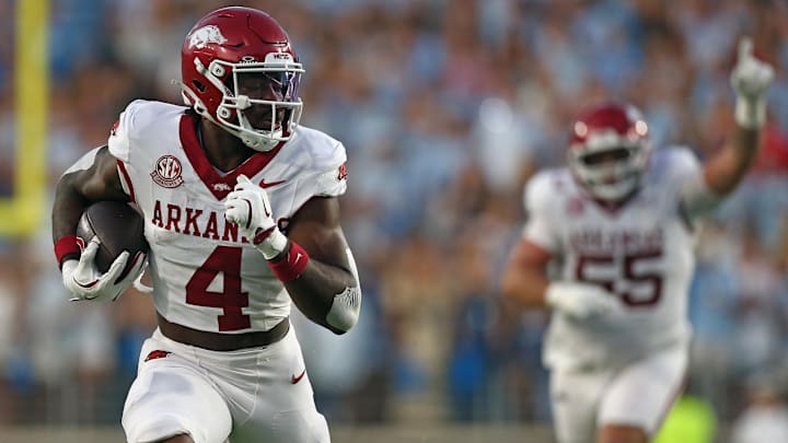 Sep 13, 2025; Oxford, Mississippi, USA; Arkansas Razorback running back Mike Washington Jr. (4) runs the ball for a touchdown during the second quarter against the Mississippi Rebels at Vaught-Hemingway Stadium. Mandatory Credit: Petre Thomas-Imagn Images