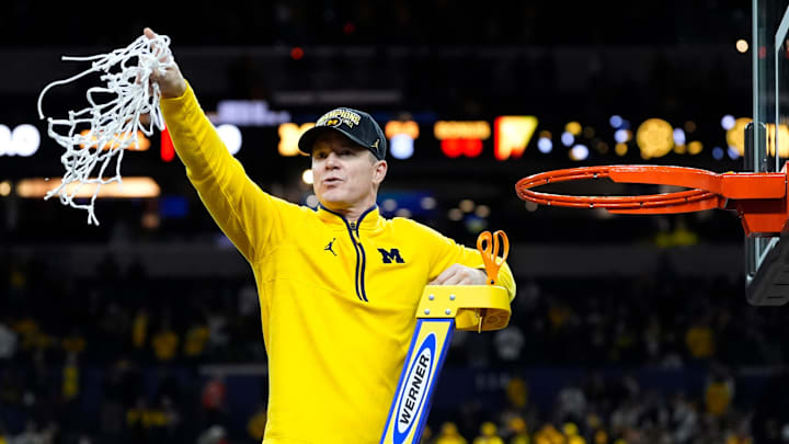 Michigan head coach Dusty May swings the net after winning the NCAA national championship against Connecticut at Lucas Oil Stadium in Indianapolis on Monday, April 6, 2026. Michigan head coach Dusty May swings the net after winning the NCAA national championship against Connecticut at Lucas Oil Stadium in Indianapolis on Monday, April 6, 2026.
