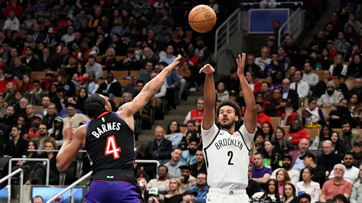 Dec 19, 2024; Toronto, Ontario, CAN;  Brooklyn Nets forward Cam Johnson (2) shoots the ball as Toronto Raptors forward Scottie Barnes (4) defends in the first half at Scotiabank Arena. Mandatory Credit: Dan Hamilton-Imagn Images