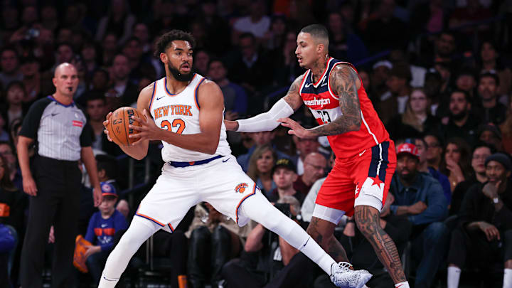 Oct 9, 2024; New York, New York, USA; New York Knicks center Karl-Anthony Towns (32) is defended by Washington Wizards forward Kyle Kuzma (33) during the first quarter at Madison Square Garden. Mandatory Credit: Vincent Carchietta-Imagn Images
