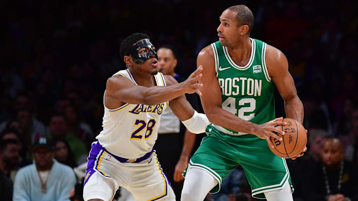 Dec 25, 2023; Los Angeles, California, USA; Boston Celtics center Al Horford (42) moves the ball against Los Angeles Lakers forward Rui Hachimura (28) during the first half at Crypto.com Arena. Mandatory Credit: Gary A. Vasquez-Imagn Images