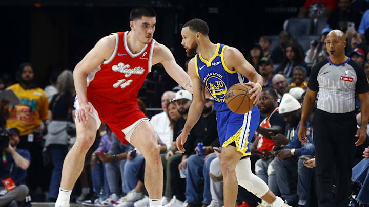 Apr 1, 2025; Memphis, Tennessee, USA; Golden State Warriors guard Stephen Curry (30) dribbles as Memphis Grizzlies center Zach Edey (14) defends during the first quarter at FedExForum. Mandatory Credit: Petre Thomas-Imagn Images