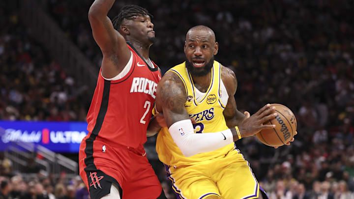Lakers forward LeBron James drives with the ball as Rockets forward Dorian Finney-Smith defends.