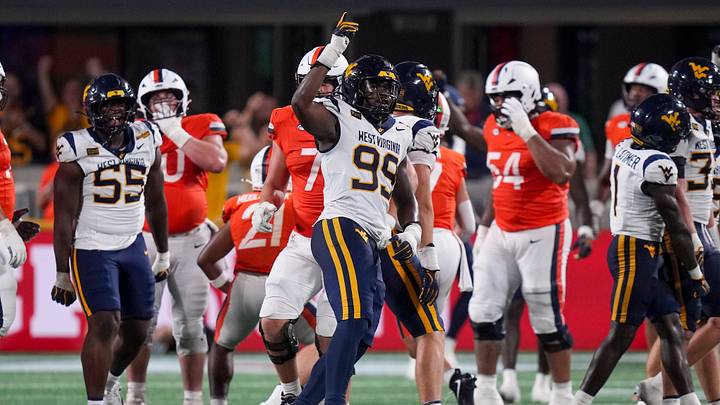 Sep 19, 2026; Charlotte, North Carolina, USA; West Virginia Mountaineers edge David Afogho (99) reacts to his sack of Virginia Cavaliers quarterback Beau Pribula (7) during the second half at Bank of America Stadium. Mandatory Credit: Jim Dedmon-Imagn Images Sep 19, 2026; Charlotte, North Carolina, USA; West Virginia Mountaineers edge David Afogho (99) reacts to his sack of Virginia Cavaliers quarterback Beau Pribula (7) during the second half at Bank of America Stadium. Mandatory Credit: Jim Dedmon-Imagn Images