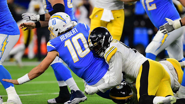 Nov 21, 2021; Inglewood, California, USA; Los Angeles Chargers quarterback Justin Herbert (10) is brought down by Pittsburgh Steelers defensive end Taco Charlton (98) during the second half at SoFi Stadium. Mandatory Credit: Gary A. Vasquez-Imagn Images