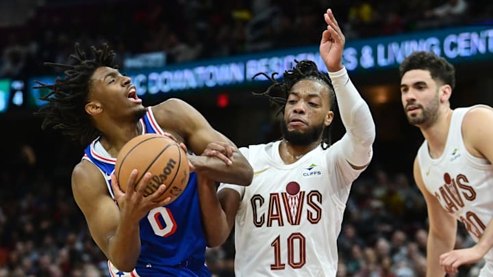 Mar 29, 2024; Cleveland, Ohio, USA; Philadelphia 76ers guard Tyrese Maxey (0) drives to the basket against Cleveland Cavaliers guard Darius Garland (10) during the first half at Rocket Mortgage FieldHouse. Mandatory Credit: Ken Blaze-Imagn Images
