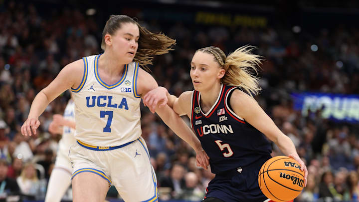 Apr 4, 2025; Tampa, FL, USA;  Connecticut Huskies guard Paige Bueckers (5) dribbles against UCLA Bruins guard Elina Aarnisalo (7) during the third quarter in a semifinal of the women's 2025 NCAA tournament at Amalie Arena. Mandatory Credit: Nathan Ray Seebeck-Imagn Images