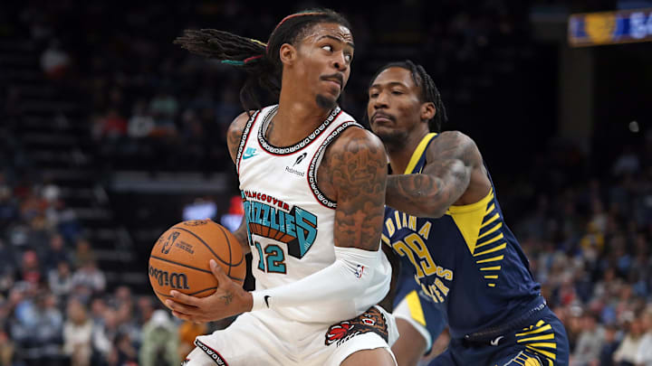 Dec 1, 2024; Memphis, Tennessee, USA; Memphis Grizzlies guard Ja Morant (12) spins toward the basket as Indiana Pacers guard Quenton Jackson (29) defends during the second quarter  at FedExForum. 