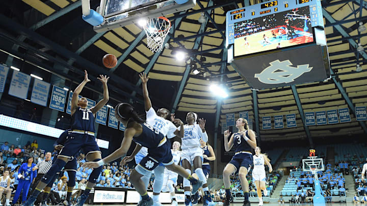 Jan 22, 2017; Chapel Hill, NC, USA; Notre Dame Fighting Irish forward Brianna Turner (11) shoots as guard Lindsay Allen (15) looks on and North Carolina Tar Heels guard Jamie Cherry (10) defends in the first half at William Donald Carmichael, Jr. Arena (Chapel Hill). Mandatory Credit: Bob Donnan-Imagn Images