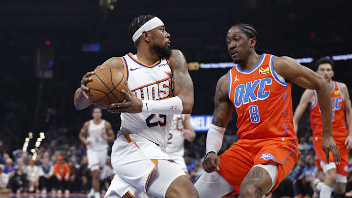 Dec 10, 2025; Oklahoma City, Oklahoma, USA; Phoenix Suns guard Jordan Goodwin (23) drives to the basket against Oklahoma City Thunder guard Jalen Williams (8) during the second quarter at Paycom Center. Mandatory Credit: Alonzo Adams-Imagn Images