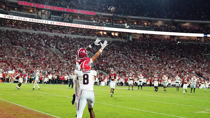 Sep 28, 2024; Tuscaloosa, Alabama, USA; Alabama Crimson Tide defensive back Zabien Brown (2) intercepts a pass intended for Georgia Bulldogs wide receiver Colbie Young (8) during the fourth quarter at Bryant-Denny Stadium. Mandatory Credit: John David Mercer-Imagn Images