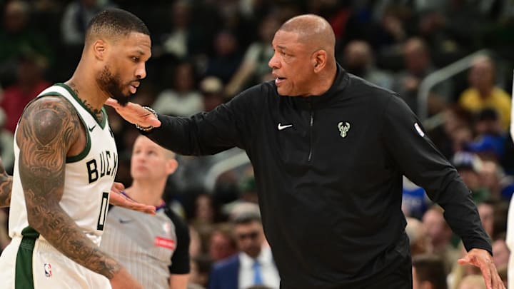 Feb 10, 2025; Milwaukee, Wisconsin, USA; Milwaukee Bucks head coach Doc Rivers pats guard Damian Lillard (0) in the second quarter against the Golden State Warriors at Fiserv Forum. Mandatory Credit: Benny Sieu-Imagn Images