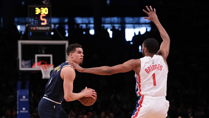 Mar 19, 2023; Brooklyn, New York, USA; Denver Nuggets forward Michael Porter Jr. (1) looks to the basket against Brooklyn Nets forward Mikal Bridges (1) during the first half at Barclays Center. Mandatory Credit: Vincent Carchietta-USA TODAY Sports