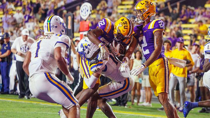 Oct 3, 2026; Baton Rouge, Louisiana, USA; LSU Tigers running back Harlem Berry (22) rushes in for a touchdown against McNeese Cowboys safety Sentario Willis (11) during the second half at Tiger Stadium. Mandatory Credit: Stephen Lew-Imagn Images Oct 3, 2026; Baton Rouge, Louisiana, USA; LSU Tigers running back Harlem Berry (22) rushes in for a touchdown against McNeese Cowboys safety Sentario Willis (11) during the second half at Tiger Stadium. Mandatory Credit: Stephen Lew-Imagn Images