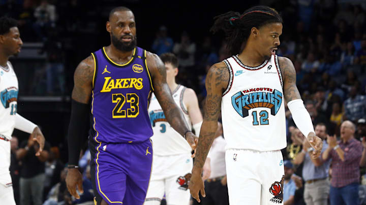  Memphis Grizzlies guard Ja Morant (12)  reacts after a technical foul as Los Angeles Lakers forward LeBron James (23) looks on during the first half at FedExForum. Mandatory Credit: Petre Thomas-Imagn Images